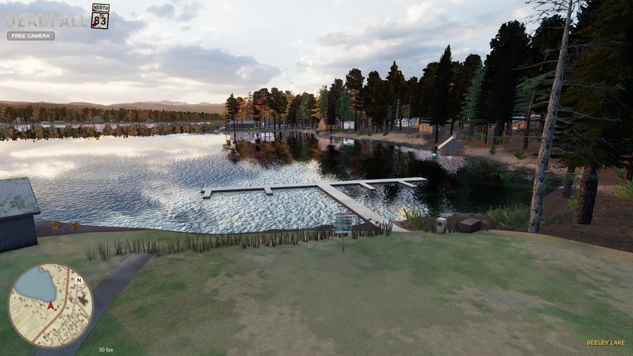 In-engine free-camera view: The dock at Lindey’s Landing, reflective lake water and forested shore at golden hour. Original minimap and location HUD remain visible.