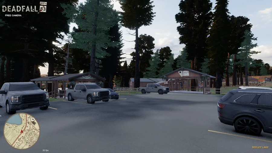 In-engine free-camera view: Lindey’s timber restaurant entrance and Bayburgers pavilion beneath tall trees at golden hour. Original minimap and location HUD remain visible.