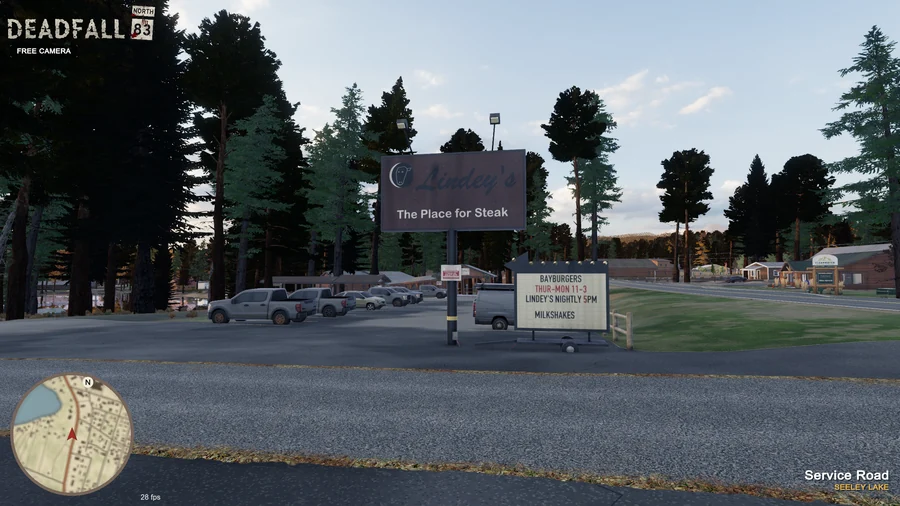 In-engine free-camera view: Lindey’s roadside steak-house sign, parking area and Clearwater office across the highway at golden hour. Original minimap and location HUD remain visible.